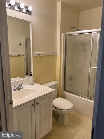 a bathroom with a sink and mirror with toilet