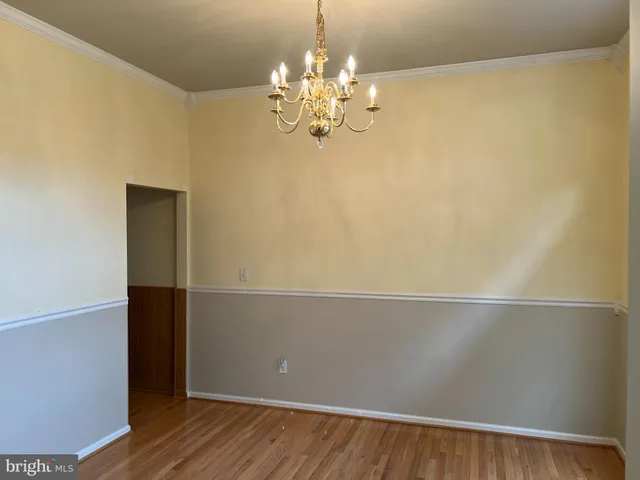 a view of kitchen with chandelier and wooden floor