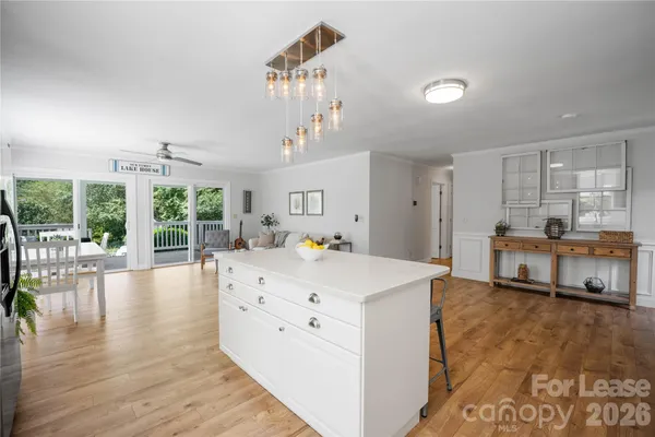 a large white kitchen with a large window