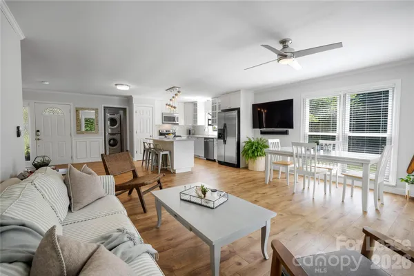 a living room with furniture a dining table and a flat screen tv