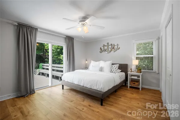 a bedroom with a large bed and a large window