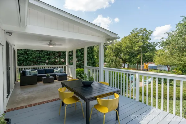 a view of a patio with a table chairs and a backyard