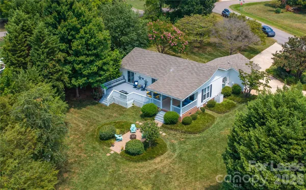 an aerial view of a house with a yard and lake view