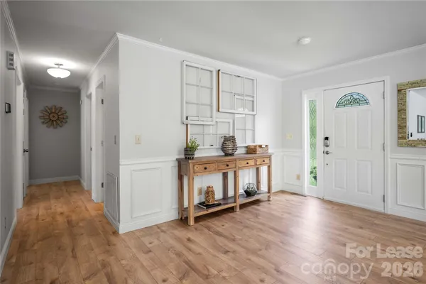 a view of a kitchen with wooden floor and a window