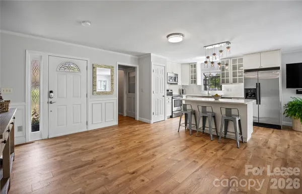 a dining room with furniture and wooden floor