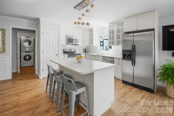 a kitchen with stainless steel appliances a refrigerator and a stove top oven