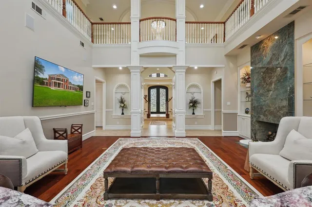 a living room with furniture a flat screen tv and a fireplace