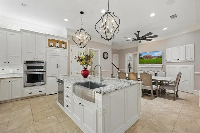 a kitchen with stainless steel appliances kitchen island granite countertop a sink cabinets and stove