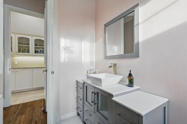 a bathroom with a sink vanity and mirror