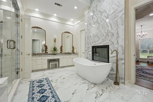 a living room with furniture a fireplace and a chandelier