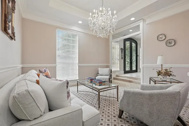 a living room with furniture and a chandelier
