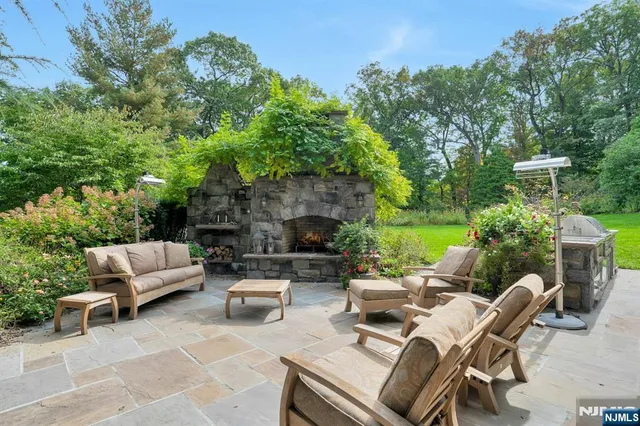 a view of a patio with couches table and chairs and potted plants