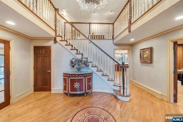 a view of entryway and hall with wooden floor