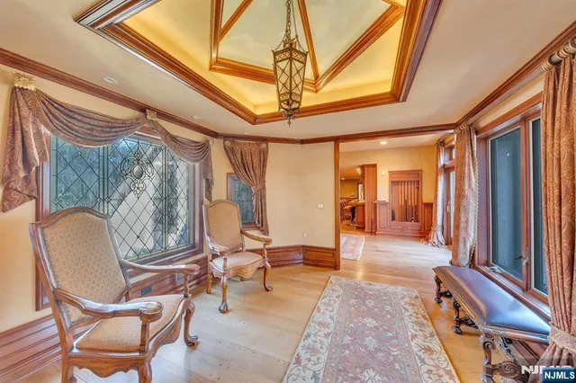 a living room with couches a table and chairs with a flat screen tv