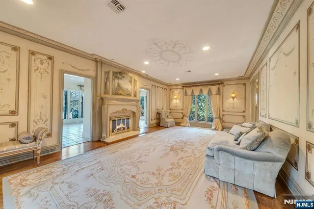 a view of a livingroom with a fireplace and cabinet