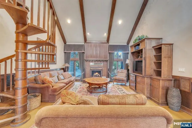 a bathroom with double vanity sinks a large mirror and a bath tub