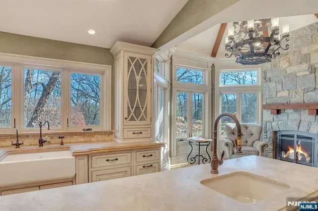 a living room with furniture a flat screen tv and a floor to ceiling window