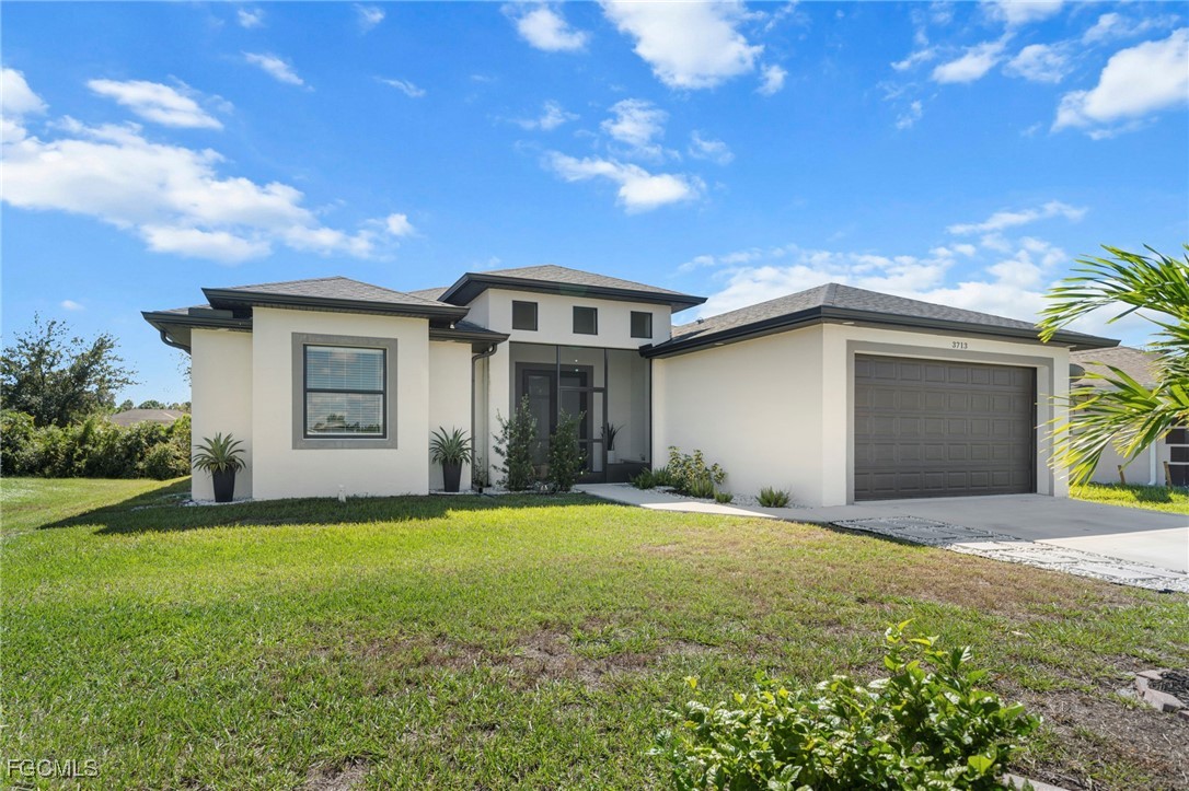 a front view of a house with a yard and garage