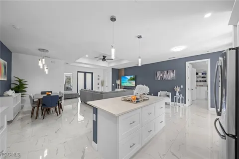 a open kitchen with white cabinets and stainless steel appliances