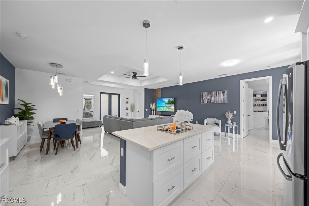 3713 25th Street Southwest Lehigh Acres, FL 33976 - Photo 11 of 31 a open kitchen with white cabinets and stainless steel appliances