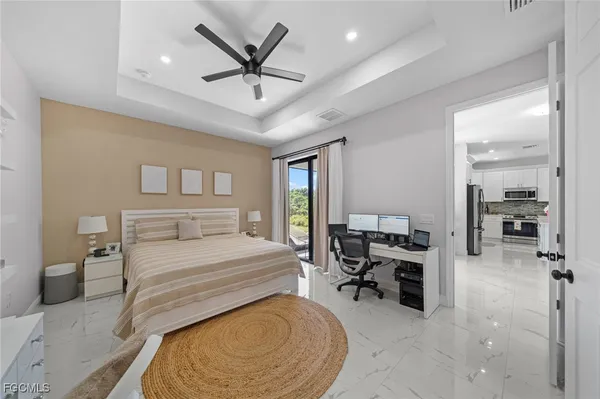 a bedroom with furniture and a large window
