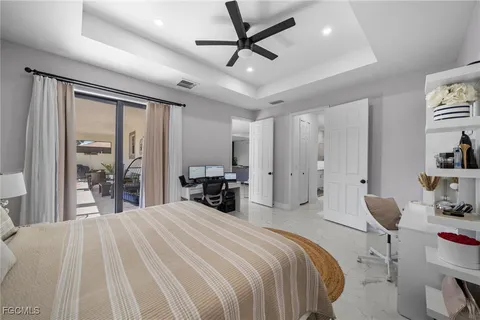 a bedroom with a bed and a large mirror