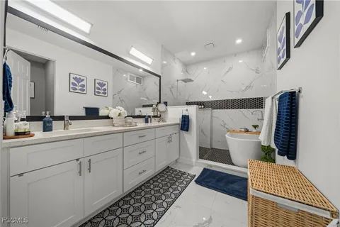 a spacious bathroom with a double vanity sink and a mirror