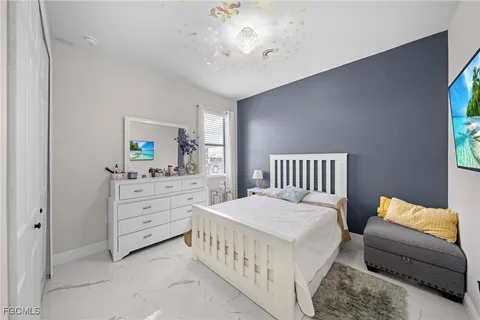 a bedroom with furniture and a window