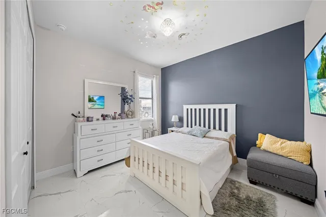 a bedroom with furniture and a window