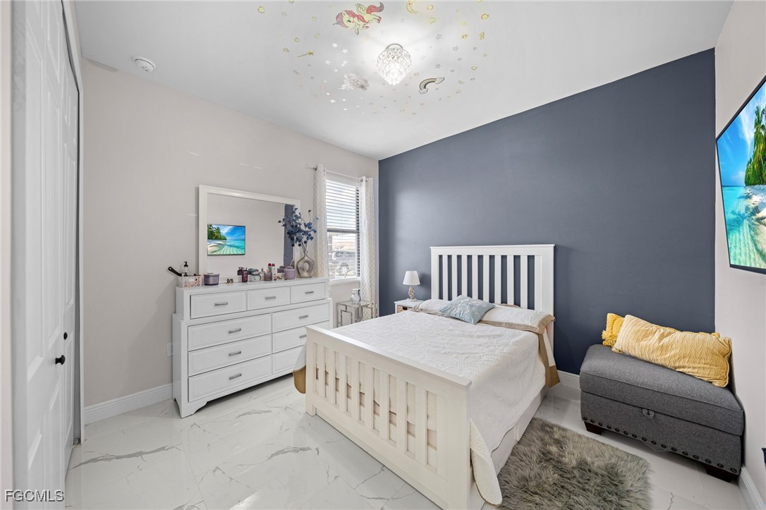 3713 25th Street Southwest Lehigh Acres, FL 33976 - Photo 20 of 31 a bedroom with furniture and a window