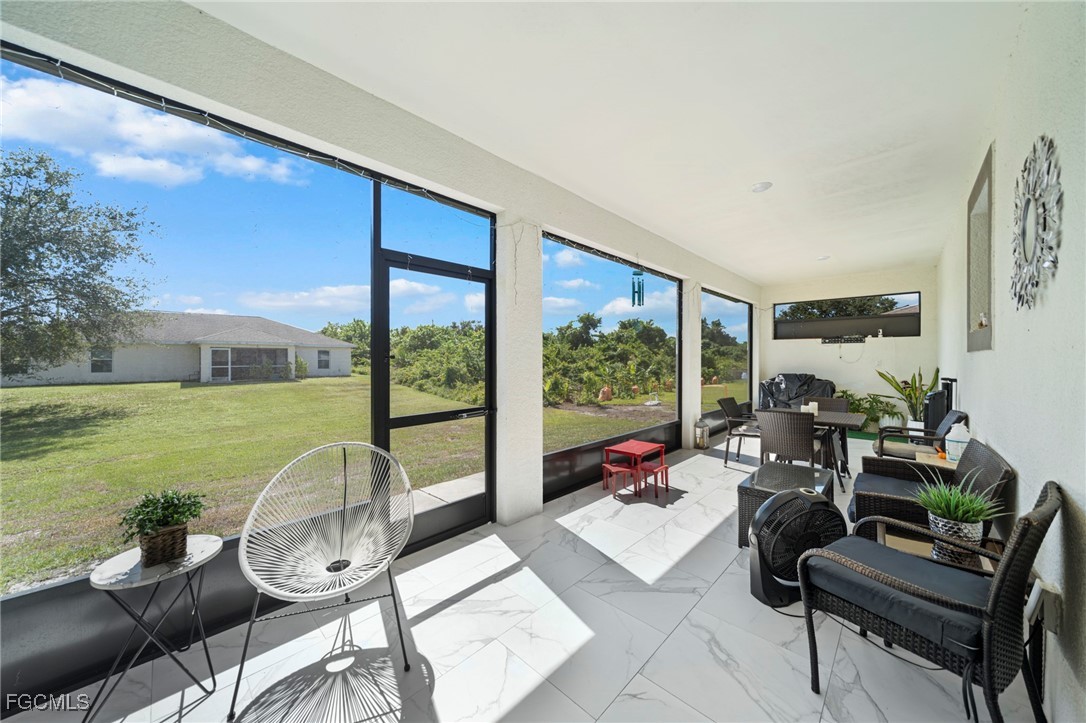 3713 25th Street Southwest Lehigh Acres, FL 33976 - Photo 24 of 31 a living room with furniture and garden view