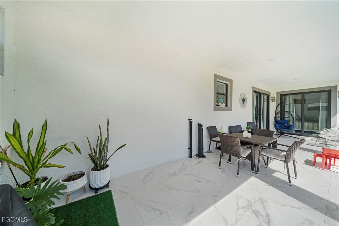 3713 25th Street Southwest Lehigh Acres, FL 33976 - Photo 26 of 31 a workspace with furniture and a potted plant