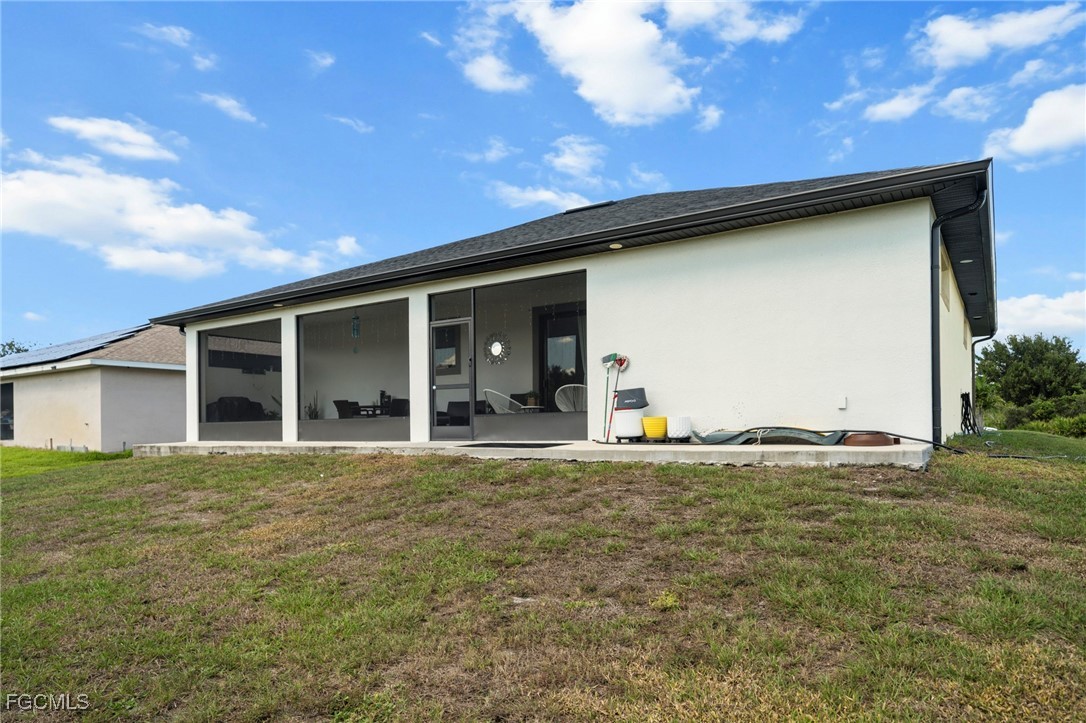 3713 25th Street Southwest Lehigh Acres, FL 33976 - Photo 27 of 31 a view of a house with backyard and porch