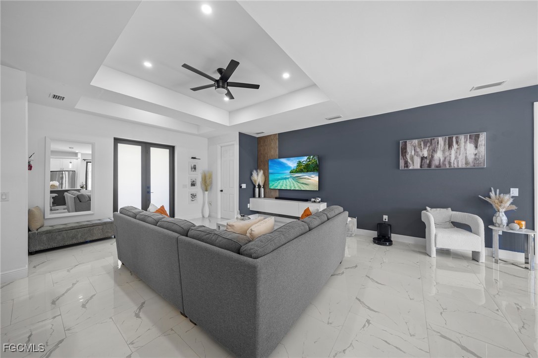 3713 25th Street Southwest Lehigh Acres, FL 33976 - Photo 4 of 31 a living room with furniture and a flat screen tv