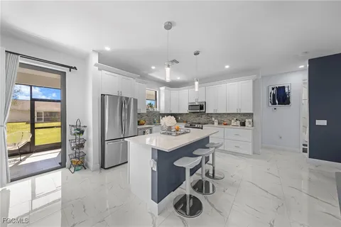 a kitchen with a sink appliances and cabinets