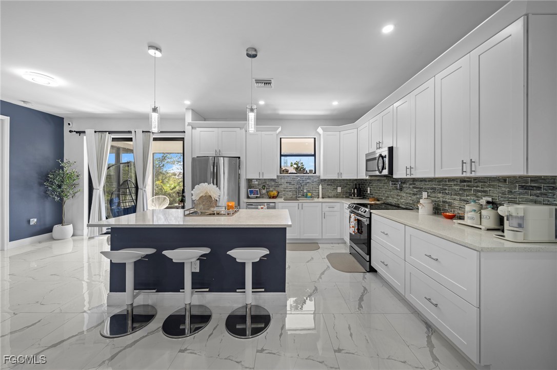 3713 25th Street Southwest Lehigh Acres, FL 33976 - Photo 10 of 31 a kitchen with a sink cabinets and window