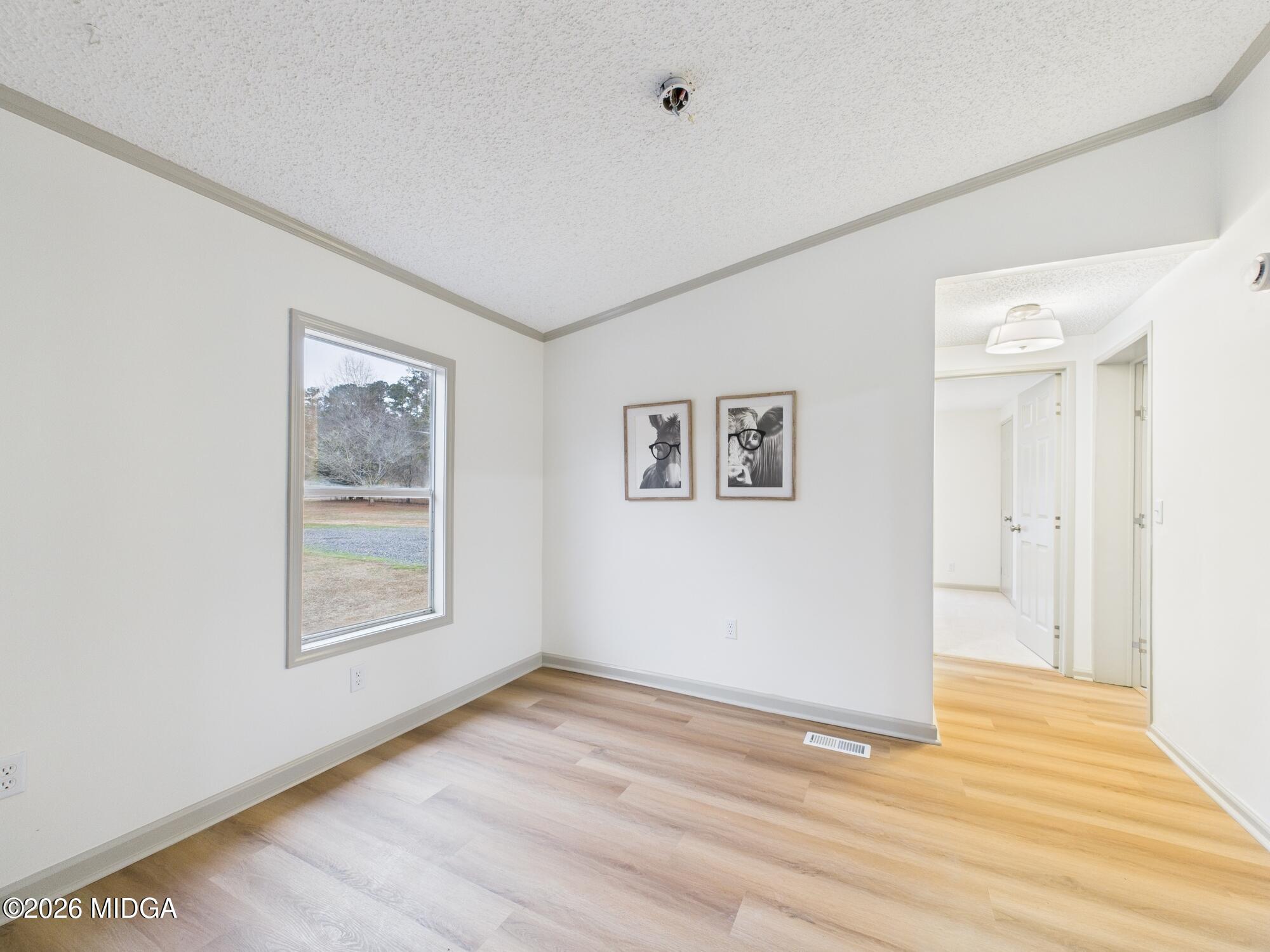 1850 Stallings Road Haddock, GA 31033 - Photo 12 of 44 a view of an empty room with wooden floor and a window