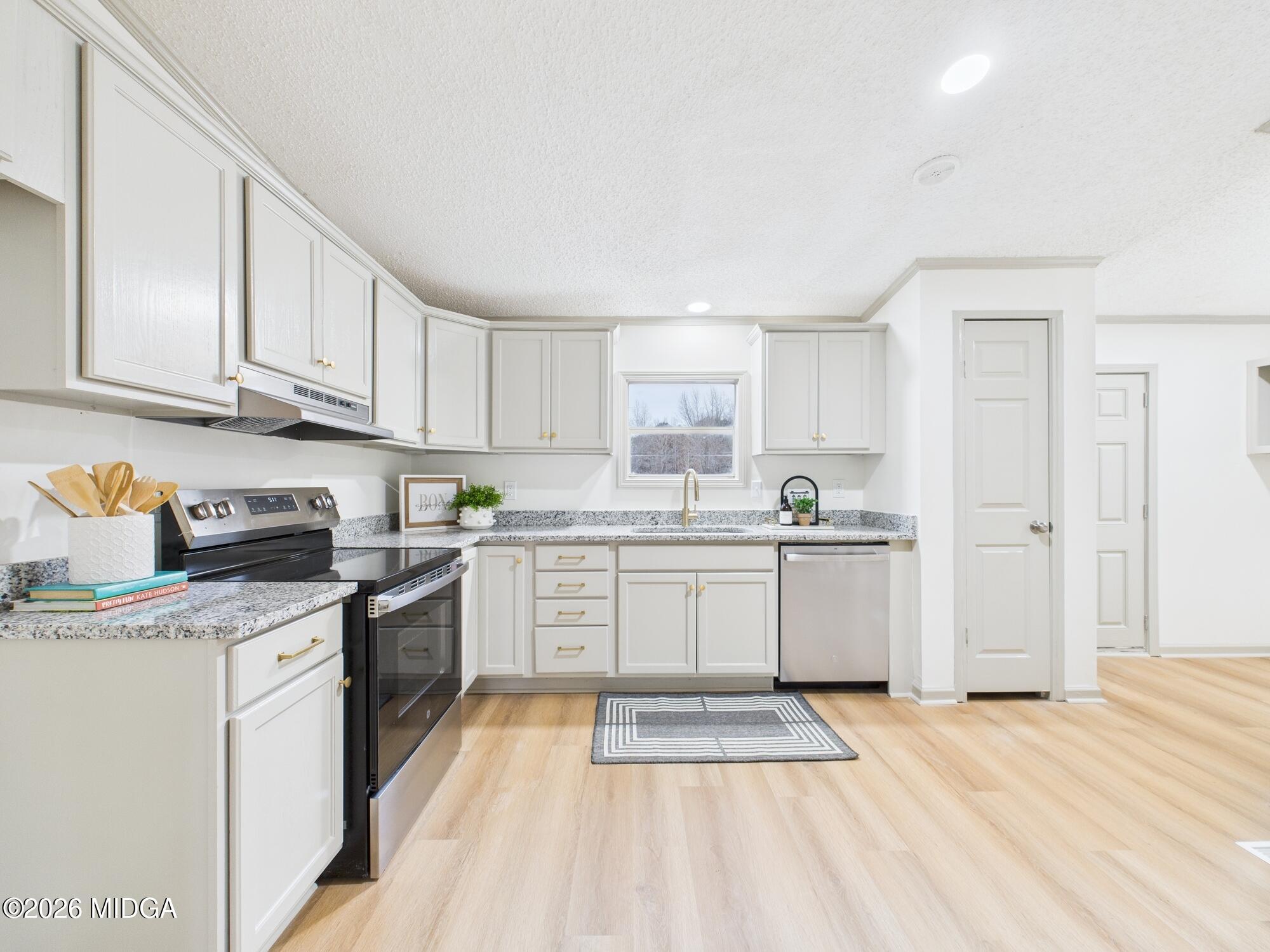 1850 Stallings Road Haddock, GA 31033 - Photo 13 of 44 a kitchen with granite countertop appliances cabinets and a sink