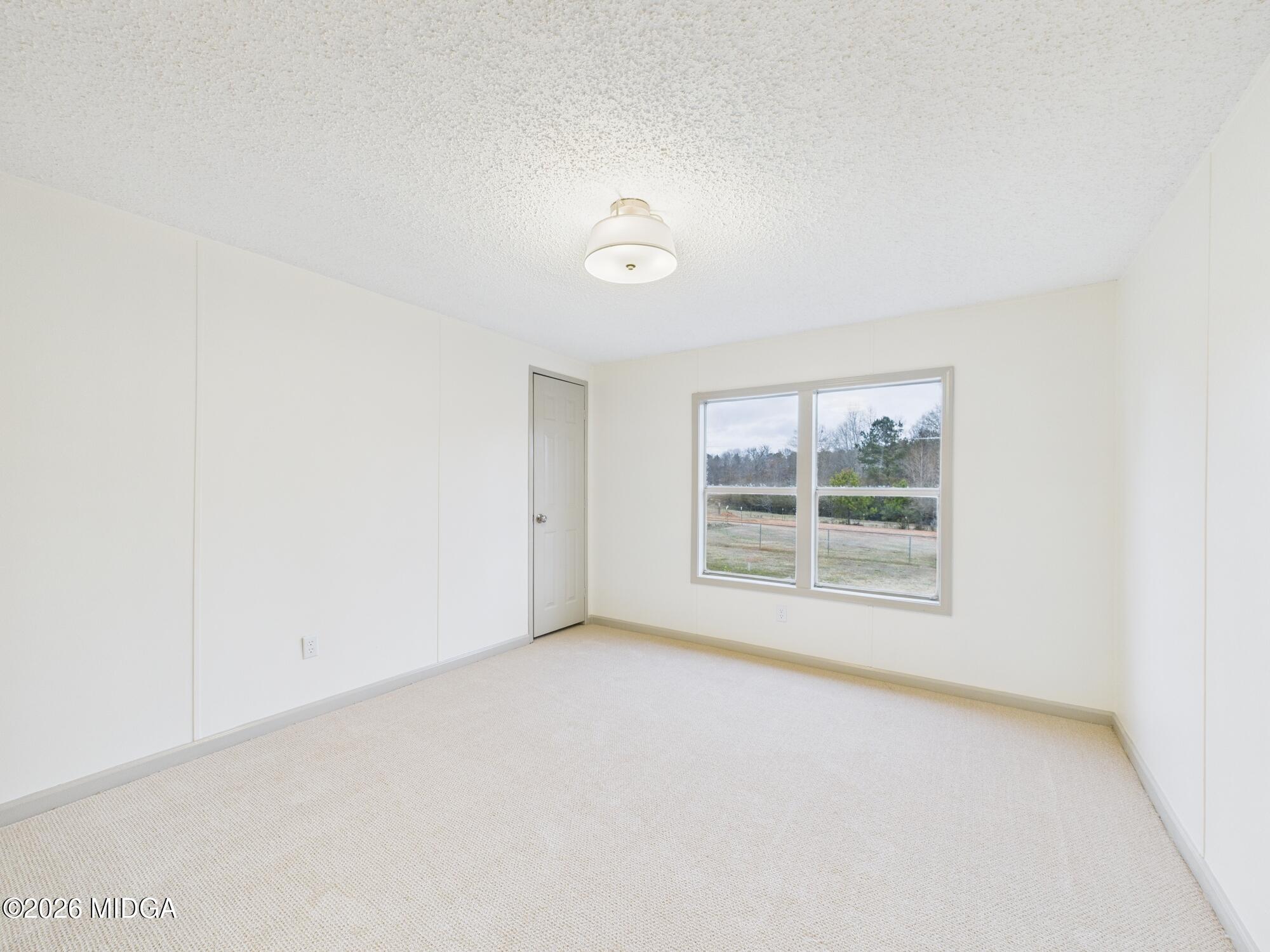 1850 Stallings Road Haddock, GA 31033 - Photo 18 of 44 an empty room with a window