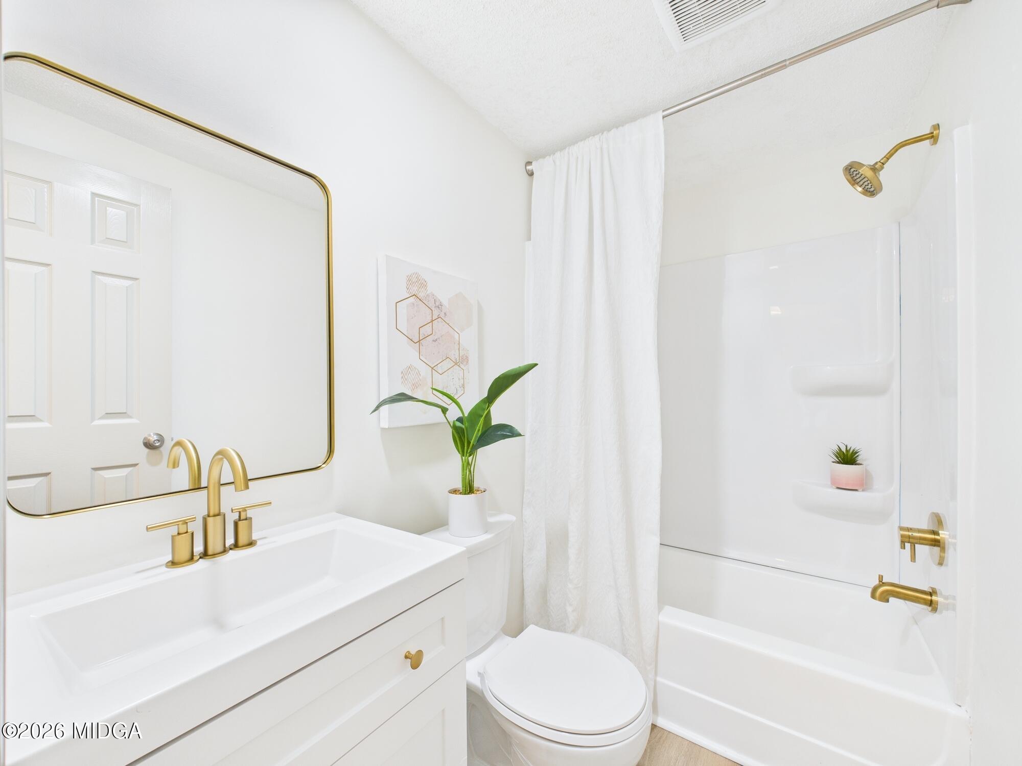 1850 Stallings Road Haddock, GA 31033 - Photo 22 of 44 a bathroom with a sink a toilet and shower