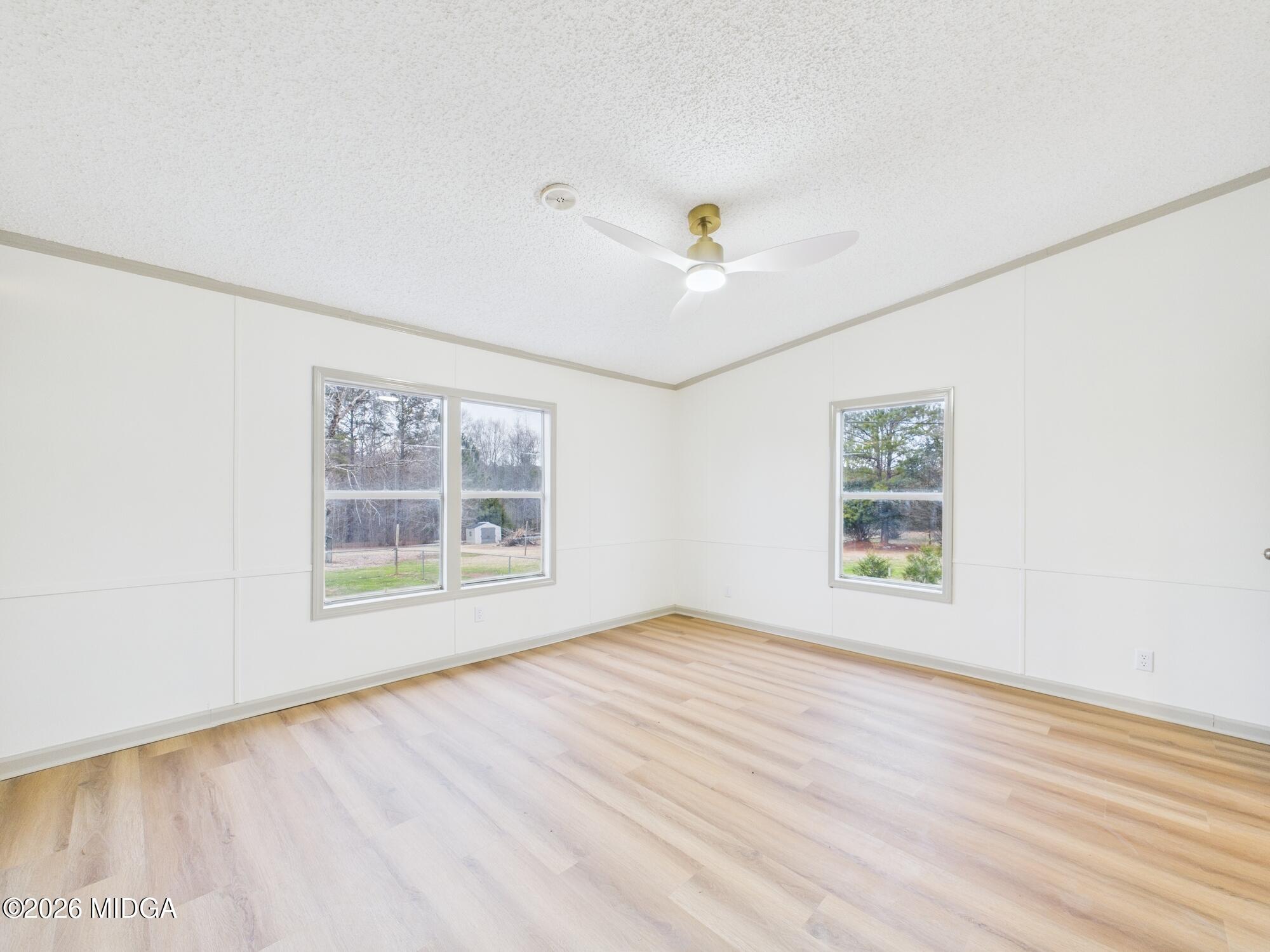 1850 Stallings Road Haddock, GA 31033 - Photo 25 of 44 a view of an empty room with a window and hardwood floor