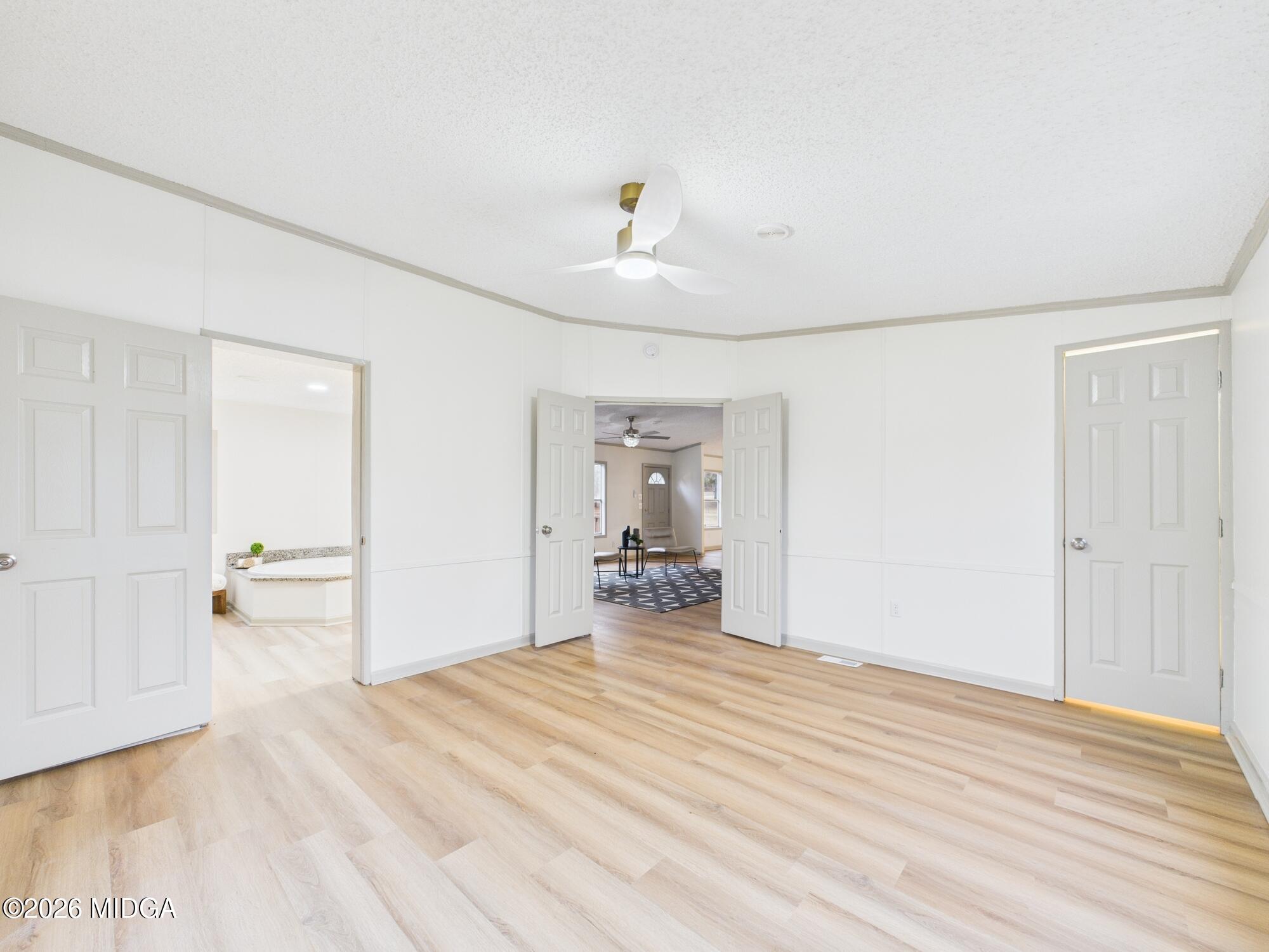 1850 Stallings Road Haddock, GA 31033 - Photo 26 of 44 a room with a bed and a chandelier