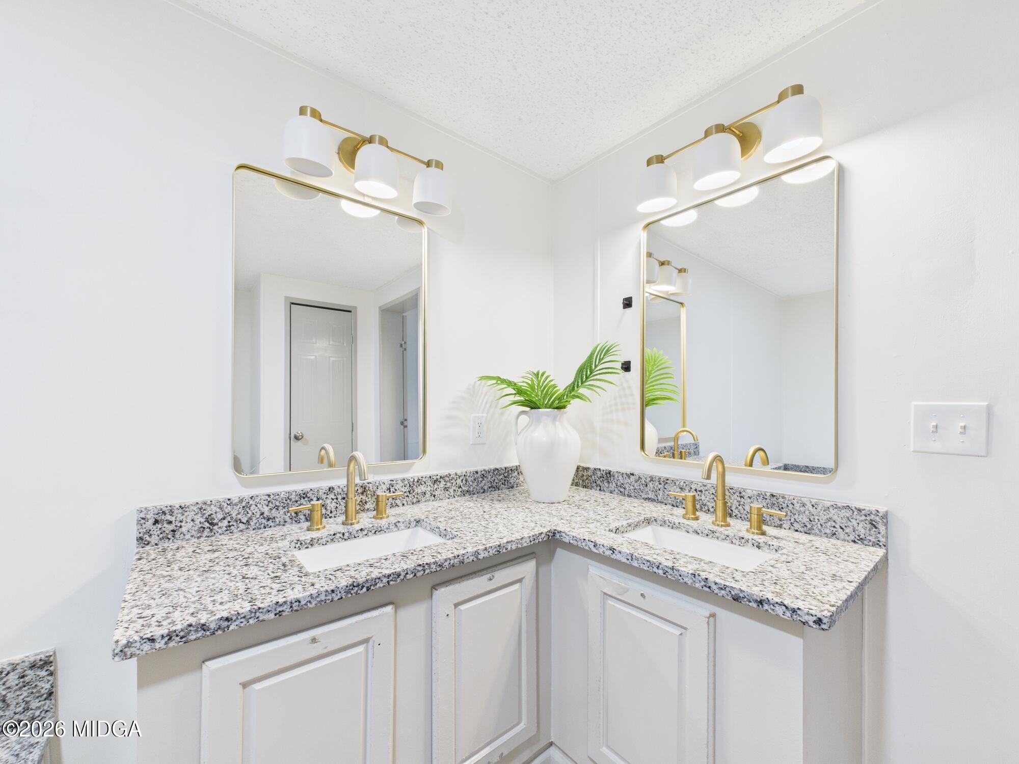 1850 Stallings Road Haddock, GA 31033 - Photo 27 of 44 a bathroom with a granite countertop sink and a mirror