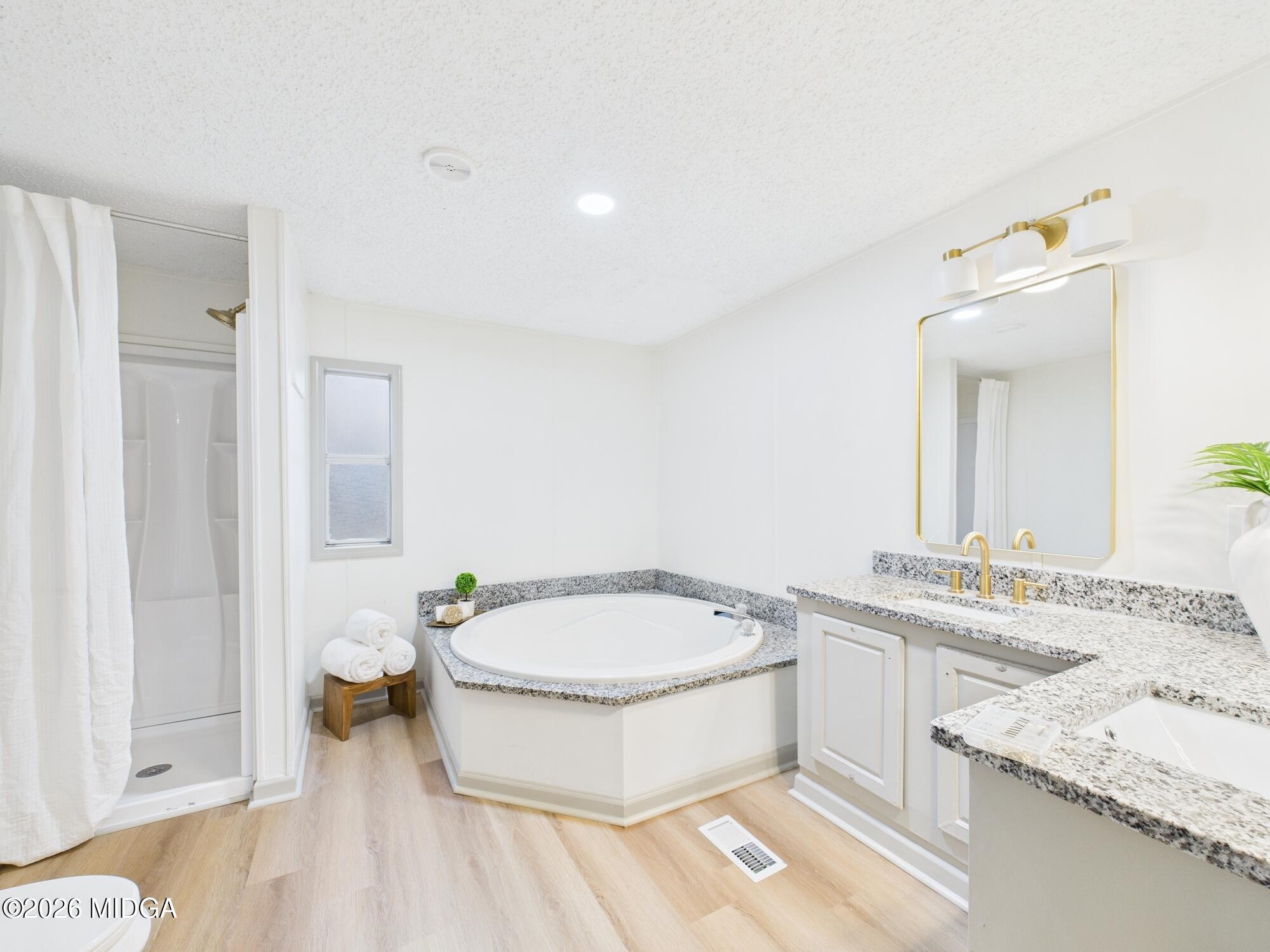 1850 Stallings Road Haddock, GA 31033 - Photo 28 of 44 a bathroom with a granite countertop sink mirror vanity and toilet