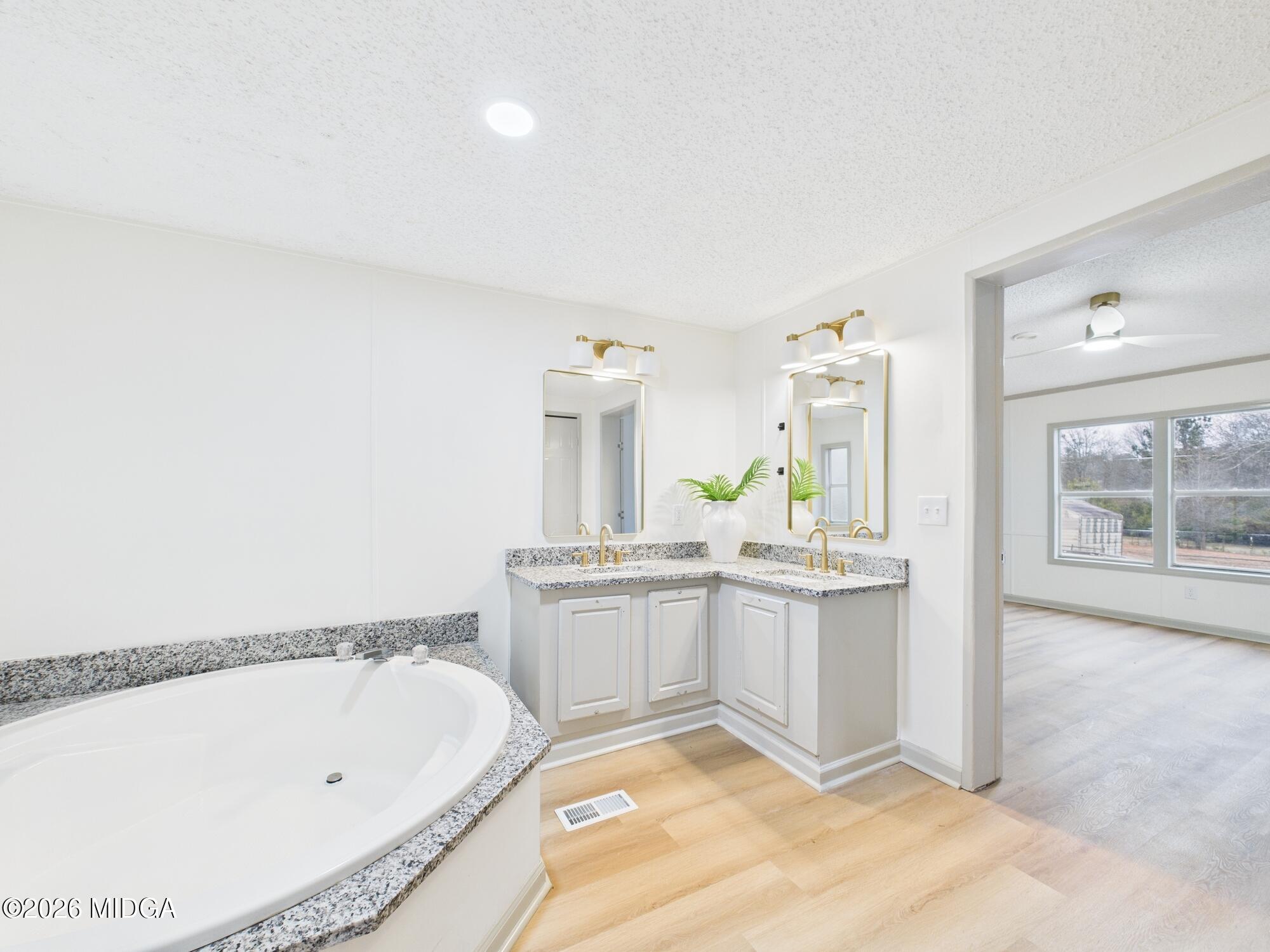 1850 Stallings Road Haddock, GA 31033 - Photo 31 of 44 a bathroom with a tub sink and mirror