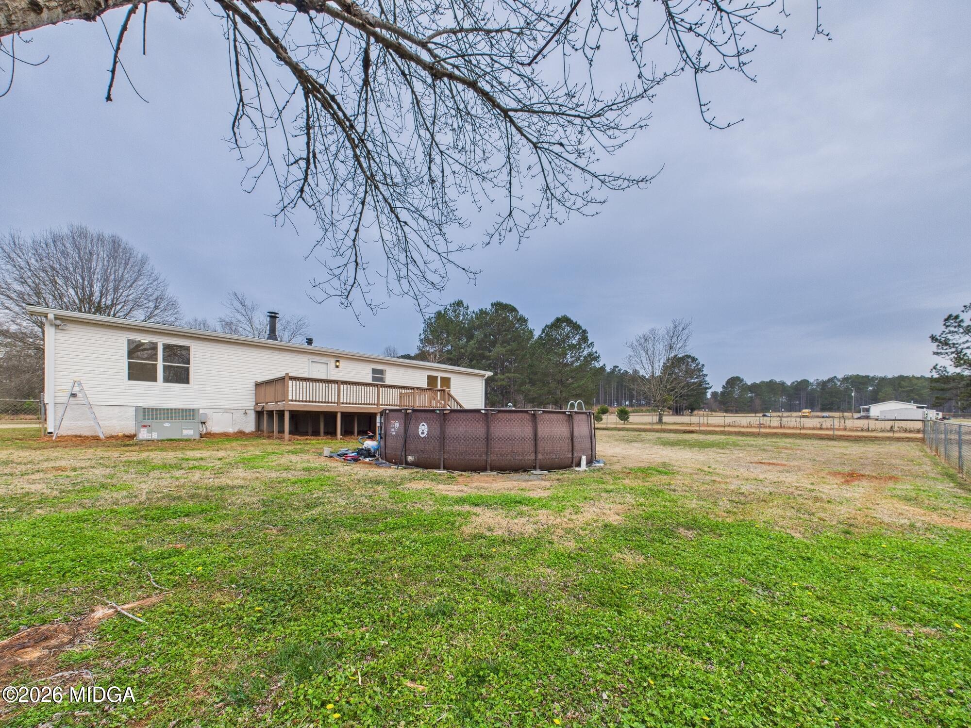 1850 Stallings Road Haddock, GA 31033 - Photo 34 of 44 a view of a house with a yard and a large tree