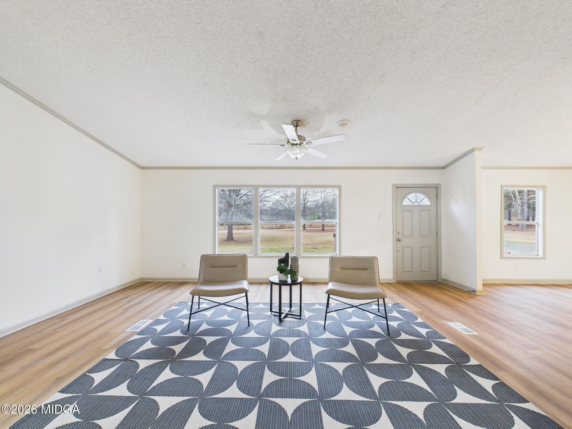 1850 Stallings Road Haddock, GA 31033 - Photo 10 of 44 a living room with a black white checkered floor with a gaming machine and dining table