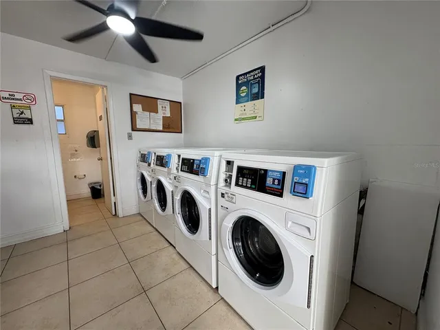 a view of washer and dryer with kitchen in the background