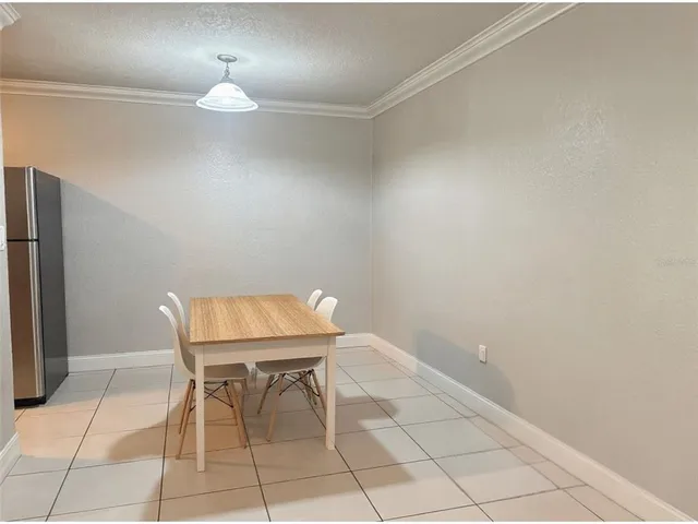 a view of a room with a table and chairs