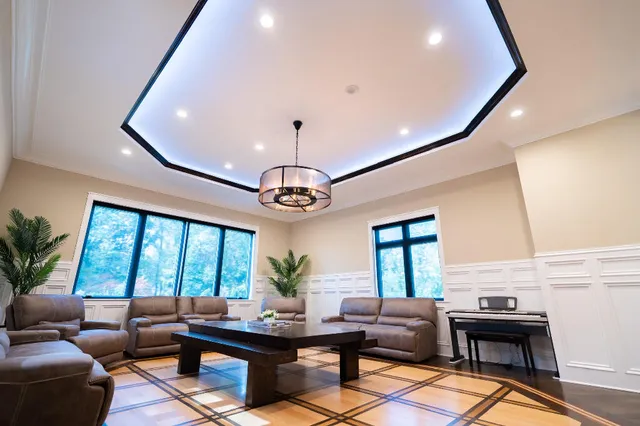 a living room with furniture ceiling fan and a rug